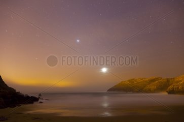 Rocky coast of the Cantabrian sea by full moon Spain