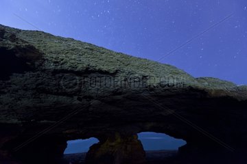 La Ojerada cave on Cantabrian coast by night in Spain