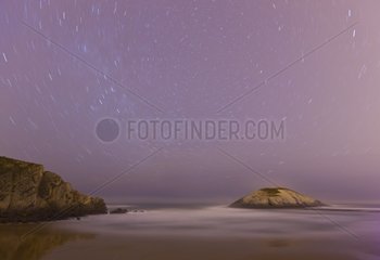 Beach and rock under the stars on the Cantabrian sea Spain