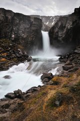 Waterfall in the fjord of Iceland Berufjordur
