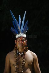 Man wearing macaw feather head dress worn during shamanic