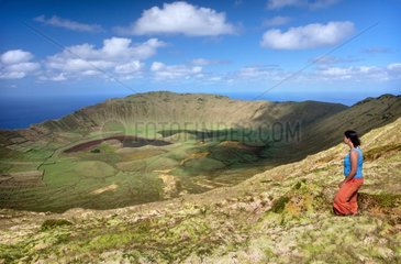 Young woman and the crater of Corvo island Azores Portugal
