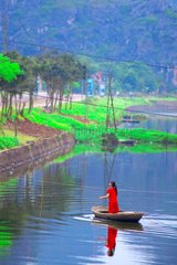 Girl crossing a river Trang An Ninh Binh Vietnam