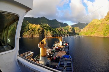 Mixed cargo and boats at anchor Polynesia Marquesas