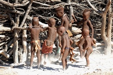 Young Himbas showing their feet covered in ash Namibia