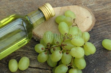 Bottle of Grapeseed Oil and Bunch of Grapes