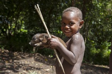 Boy and mid-wild pig - Tanna Island Vanuatu