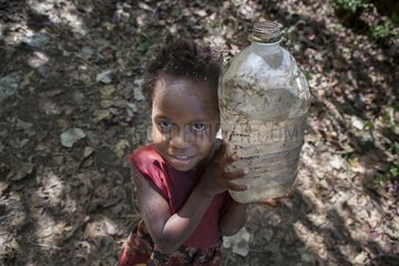 Girl and bottle of drinking water - Tanna Island Vanuatu