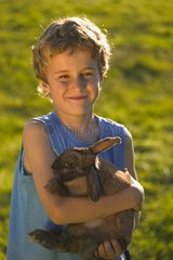 Portrait of a boy holding a Rabbit in his arms Netherlands