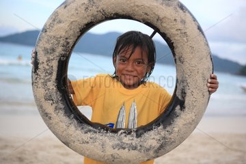 Girl playing with a tire Perhentian Kecil Malaysia