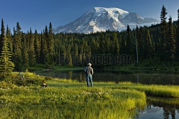 Photographer in meadows Mt Rainier NP USA