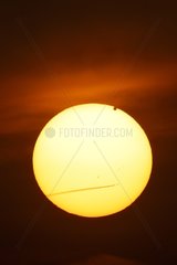 Transit of Venus with the Sun and a plane contrail Spain