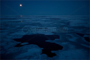 Moon over the ice of Baffin Bay Canada