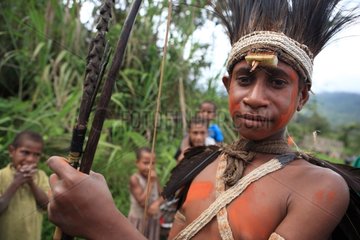 Boy with feather headdress and bow Papua New-Guinea
