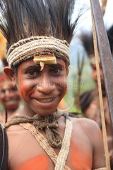 Boy with feather headdress and bow Papua New-Guinea