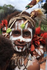 Girl with feathers and paint Papua New-Guinea