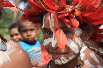Girl with red feather headdress Papua New-Guinea