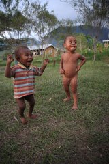 Young Boys jumping in the grass Papua New-Guinea