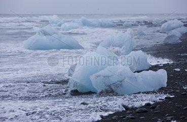 Iceberg Lake Joekulsárlón lapping on the beach Iceland