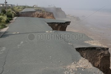 Collapsed tarmac road following cliff erosion on coast Yorks
