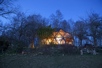 Geodesic shaped ecohouse by night in Ariège France