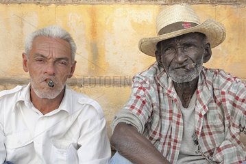 Portraits of Cuban men smoking a cigar in Trinidad Cuba