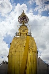 Standing Buddha at Wat Intharawihan Temple in Thailand