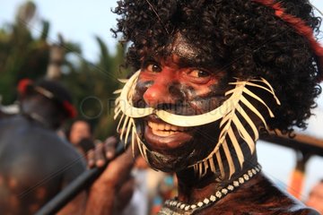 Man with bone in the nose and body painting New Guinea