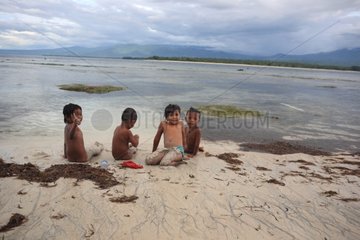 Children playing on the sand at low tide Gili Air Indonesia