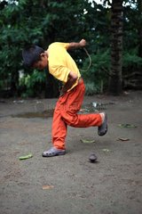 Boy playing with a top Gangga Lombok Indonesia