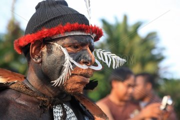 Man with bone in the nose and body painting New Guinea