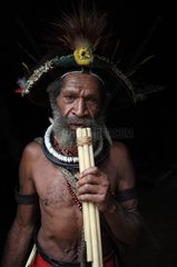 Huli man playing the flute Papua New-Guinea