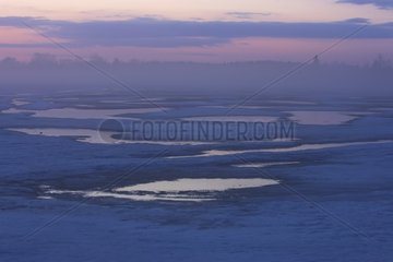Frozen lake at sunset Finland
