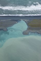 Vatnajoekull glacier melt flowing into the ocean Iceland