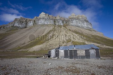 Trapper's cabin and cliff Spitzbergen Norway