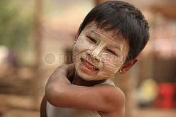 Portrait of a boy covered with protective cream Burma