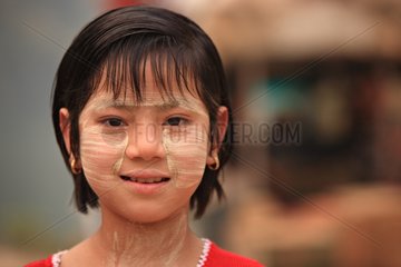 Portrait of a girl covered with protective cream Burma