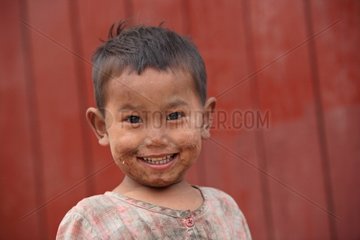 Portrait of a young boy smiling in Burma