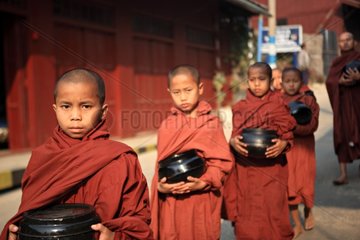 Young monks doing the quest with their bowl in Burma