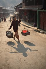 Woman carrying dishes cooked in the morning in Burma