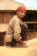 Man sitting in a village in Burma