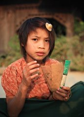 Girl playing cards in a village in Burma