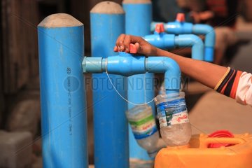 Boy filling his water bottle drinking Burma