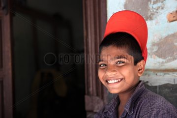 Portrait of a smiling boy with a red cap India