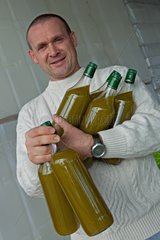 Man holding bottles of oil Olives France