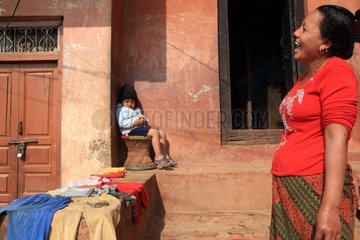 Woman laughing and boy eating peanuts Nepal