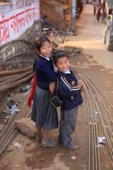Schoolchildren in uniform smiling in the street Nepal