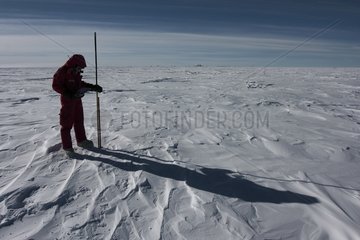 Glaiologue measuring snowfall Concordia Antarctic