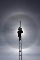 Sundog behind a man on a mast Concordia Antarctic