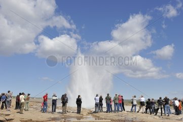 Tourists and Geyser on the site of Geysir Iceland